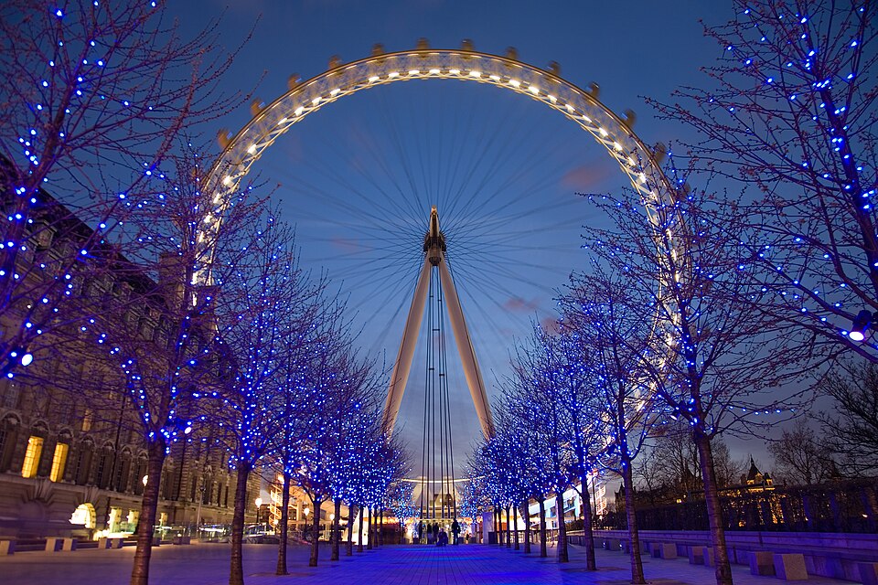 The illuminated London Eye seen from below against a twilight sky